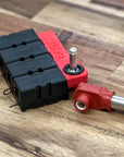 Black and red battery connectors on a wooden surface