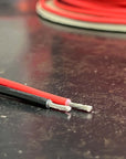 Close-up of LSZH Automotive Wire (per meter) showing tinned copper strands in red and black insulation.