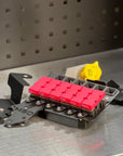 Ford F150 2021-Current MIDI Fuse Kit with red fuses and mounting hardware on a metal surface.
