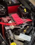 N80 Hilux (2015-Current ) Battery Fuse Bracket Kit installed in vehicle engine bay with red fuse holders.