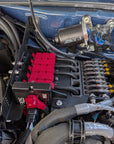 Close-up of a car engine with various components and wiring.