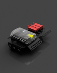 Small robot or electronic device with transparent top and red and black components on a dark background
