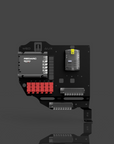 Electronic module with red and gray components on a reflective surface