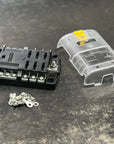 Blue Sea Systems ST Blade Fuse Block - 6 Circuits with Negative Bus and Cover (5025) shown with cover and mounting hardware.