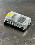 Blue Sea Systems ST Blade Fuse Block - 6 Circuits with Negative Bus and Cover (5025) on a dark surface.