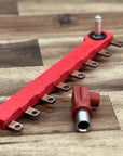 Red metal bracket on a wooden surface