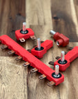 Red mechanical components on a wooden surface