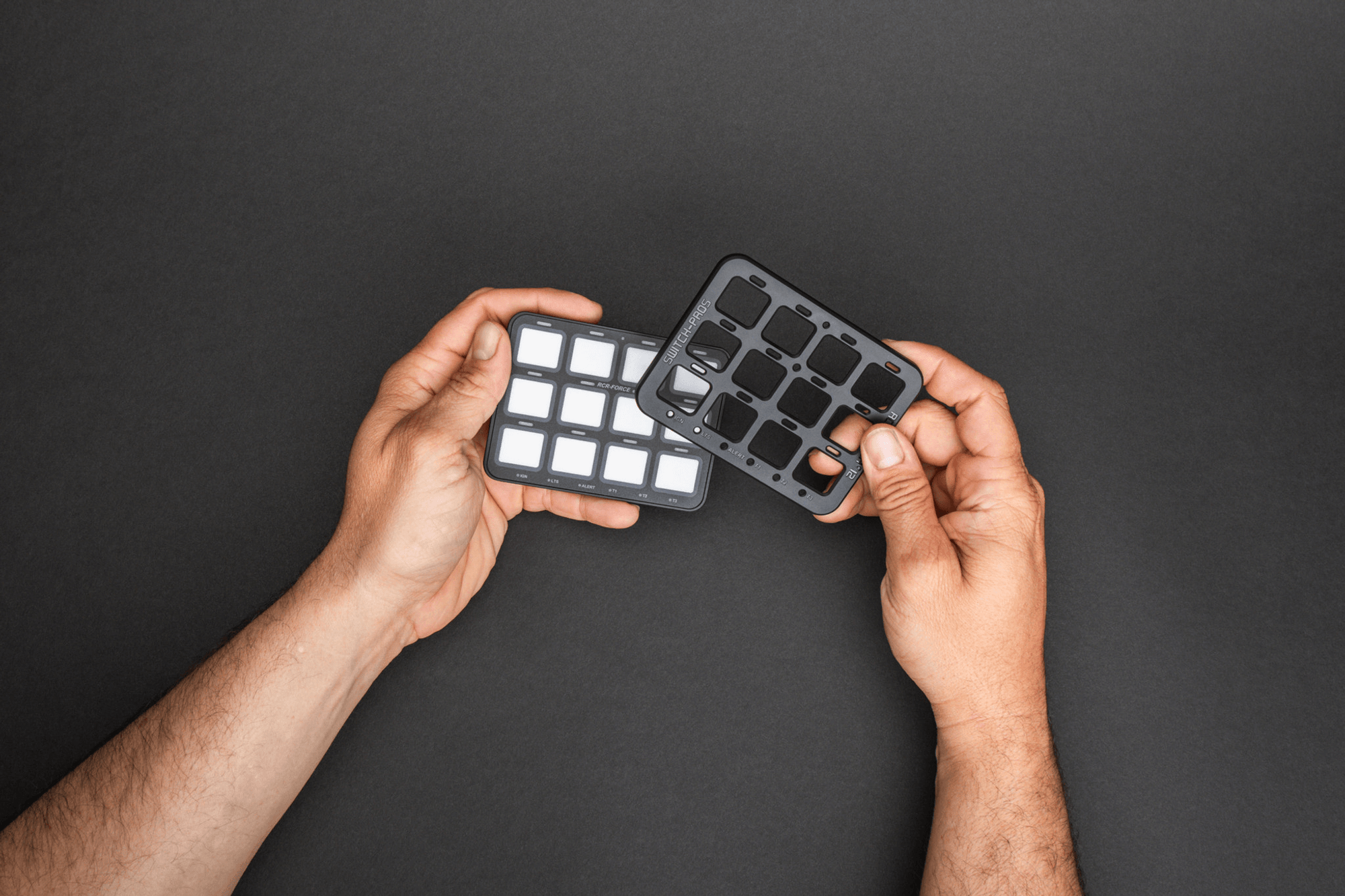 Hands holding two switch panels for a Switch Pro setup, showcasing versatile slave panels and accessories.