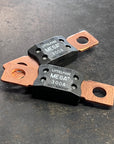 Two LittleFuse Mega Fuses rated at 300A displayed on a dark surface, ideal for high current applications.