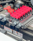 GU Patrol Battery Fuse Bracket with red fuse holders and relays installed, showcasing an organized 12-volt electrical system.
