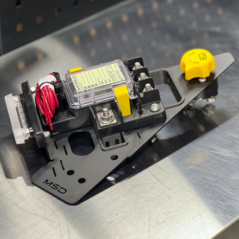 Mechanical component with wiring and a yellow cap on a metallic surface