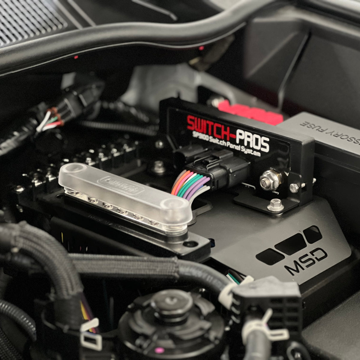 Toyota Hilux engine bay with a switch pros unit and electrical accessories 