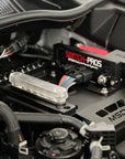 Toyota Hilux engine bay with a switch pros unit and electrical accessories 