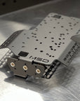 Metal component with 'MSD' branding on a reflective surface