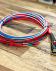 Coiled wiring harness with connectors on a wooden surface