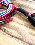 Colorful wiring harness with connectors on a wooden surface