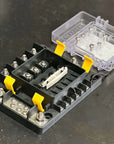 Blue Sea Safety-Hub 150 Fuse Block with transparent cover and multiple fuse slots on a black base.