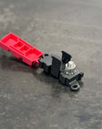Bussmann LMI Input Module with red cover and silver stud on a grey background.