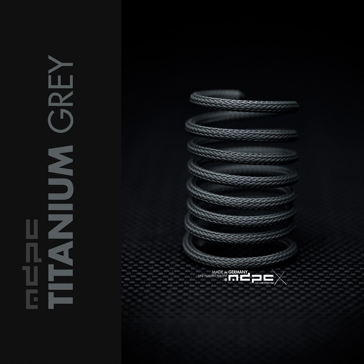 Titanium Grey Braided Cable Sleeve coiled, showcasing its unique medium grey shade for PC builds.