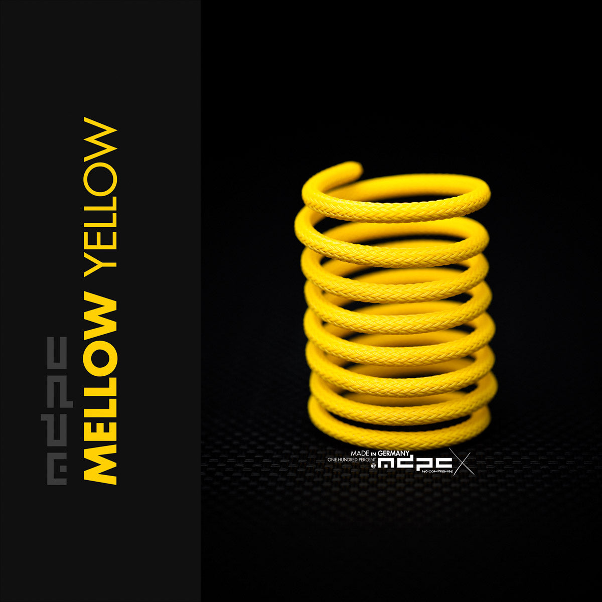 Mellow Yellow Braided Cable Sleeve displayed in a spiral arrangement, showcasing its vibrant color and braided design.