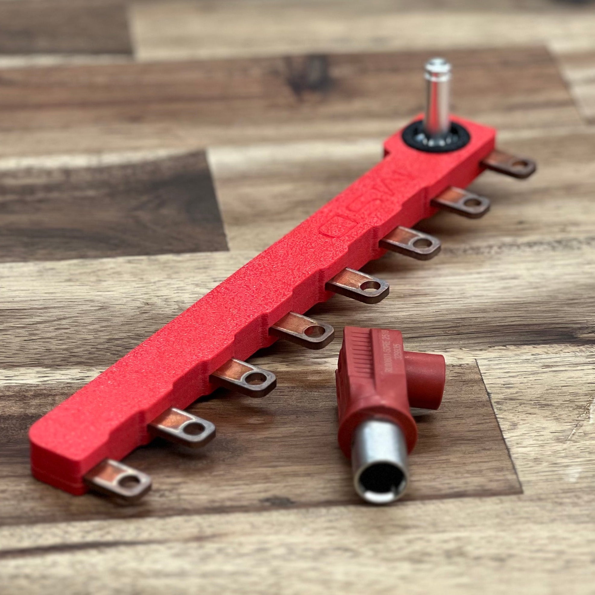 Red metal bracket on a wooden surface
